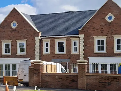 large house with white circle widnows at the top