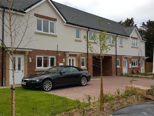 A car is parked in front of a house.