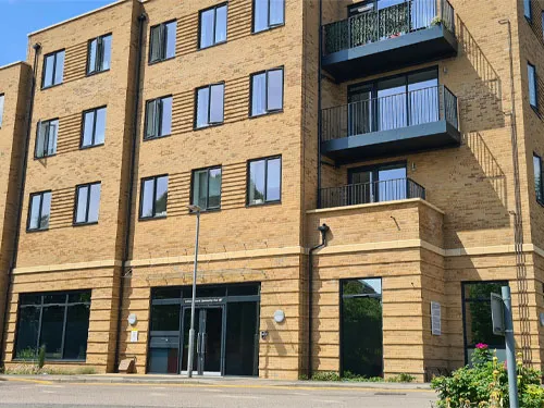 A tall brick building with balconies and balconies.